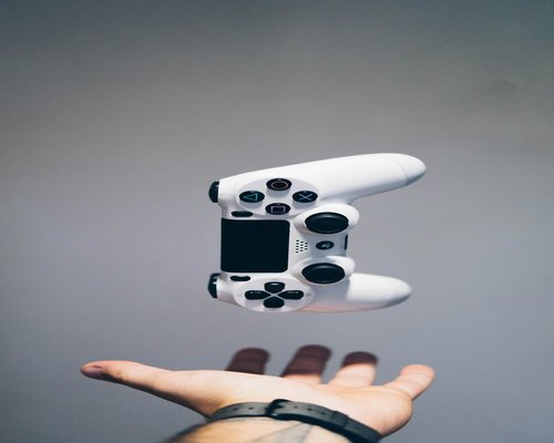 Modern white gaming console and wireless controller